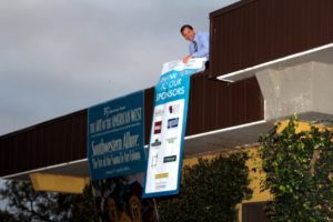 Lui, Executive Director, Hangs Banner off the side of the art museum.